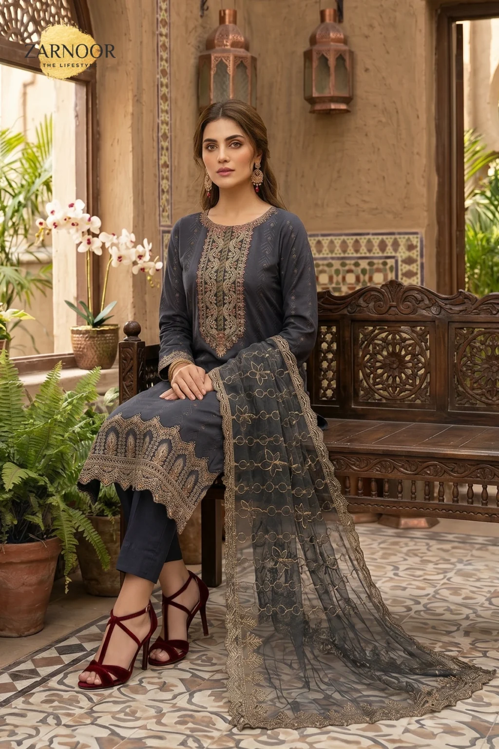 Woman wearing navy blue embroidered lawn 3 piece unstitched suit with sequins work and embroidered dupatta